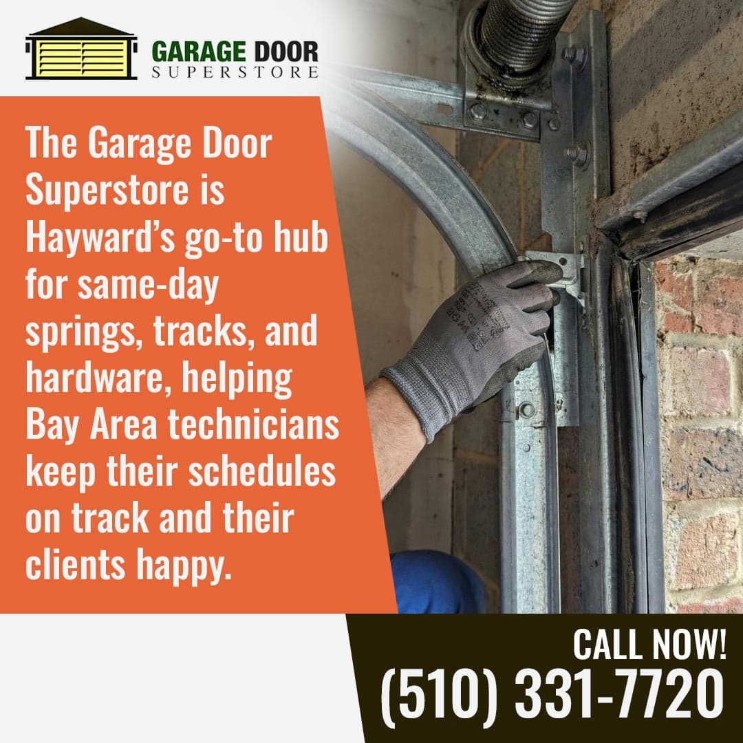 Technician adjusting garage door track hardware inside a garage