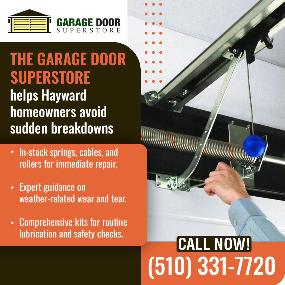 Garage door spring and cable system with technician performing maintenance in Hayward